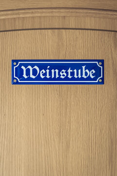 "Wine tavern" Weinstube sing in german Gothic font on Wooden door 