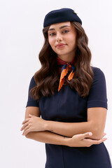 Confident young flight attendant in a chic navy cabin crew uniform © LIGHTFIELD STUDIOS