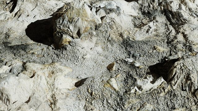 Rough rock and stone texture with natural cracks and fissures, high contrast overhead geological surface background