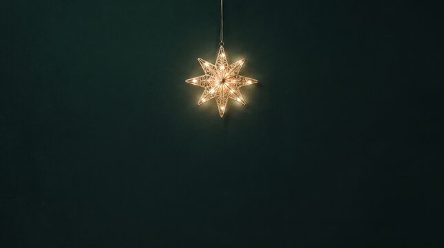 Glowing Golden Snowflake Ornament on Dark Green Background
