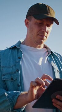 Farmer maintains automation with digital tablet in wheat field