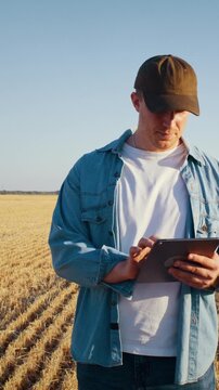 Farmer monitors agricultural data via digital tablet in field