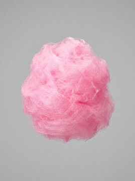 Professional studio shot of a fluffy pink cotton candy treat isolated on gray