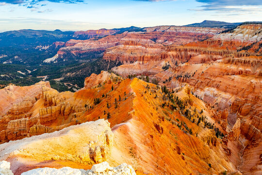 Sunrise light glows across Cedar Breaks amphitheater cliffs
