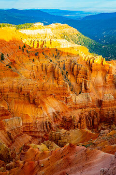 Sunrise light glows across Cedar Breaks amphitheater cliffs