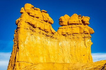 Weathered sandstone hoodoo pillars stand against clear desert sky © PhotoSpirit