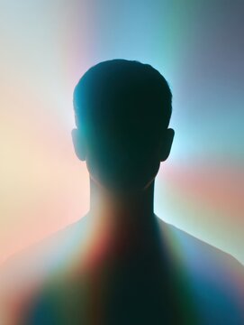 Abstract glowing aura silhouette of human man head and shoulders colorful neon light halo background mental health spiritual wellness inner peace consciousness energy body holistic concept design