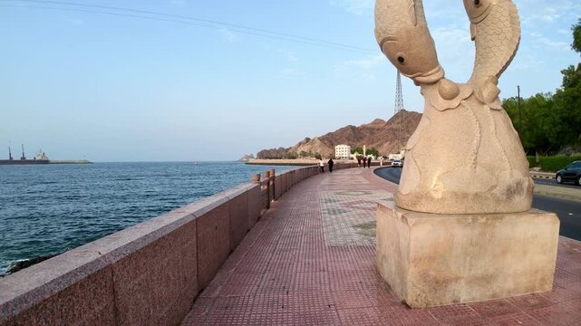 Muttrah Corniche in Muscat, Oman, featuring waterfront views, traditional architecture, harbor scenery, and coastal mountains. Muscat, Oman - August 03, 2026