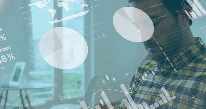 Analyzing man wearing yellow-blue plaid shirt reviewing dashboard overlays in office, with laptop