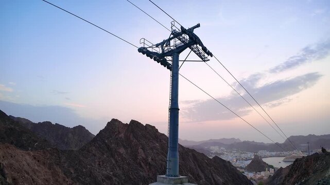 Muttrah cable car views in Muscat, Oman, featuring rugged mountains, cruise ships, and a scenic harbor at sunset. Muscat, Oman - October &lrm;21, &lrm;2026