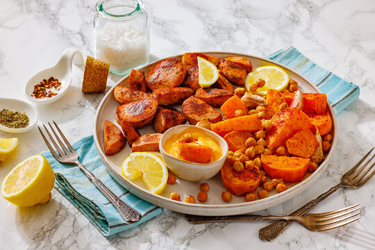 sliced sausage with sweet potato wedges, chickpeas