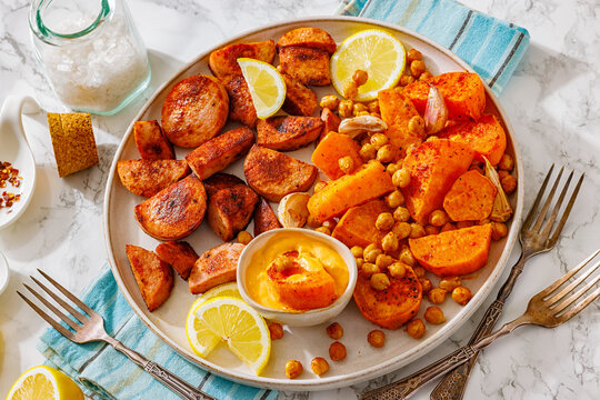 Browned sausage pieces with sweet potato wedges