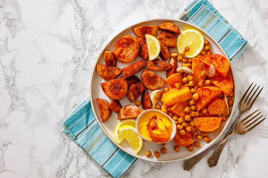 sliced sausage with sweet potato wedges, chickpeas