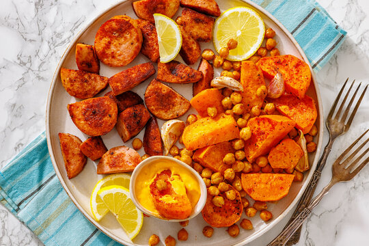 roasted sliced sausage with sweet potato on plate