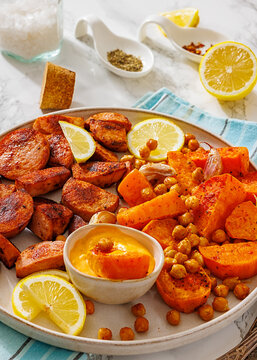 Browned sausage pieces with sweet potato wedges