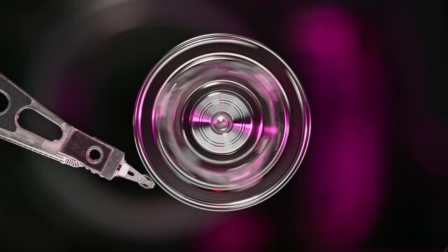 Extreme close-up of a hard disk drive reading data with spinning metallic platters. Ideal for technology, data storage, and computing concepts.