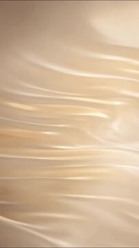 Elegant golden silk fabric flowing in smooth waves with luxurious creamy reflections for premium motion backgrounds