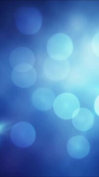 Shimmering blue bokeh circles floating smoothly through soft atmospheric light leaks, creating dynamic movement