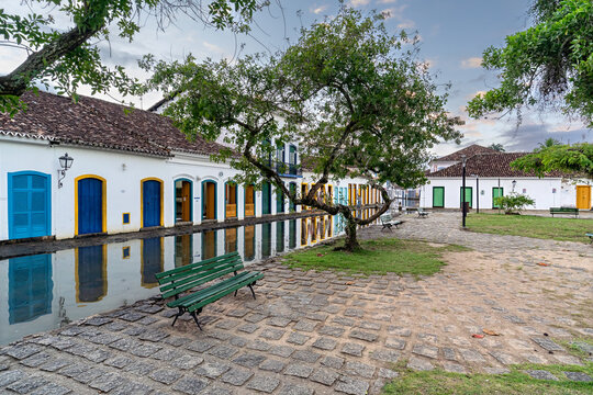 Paraty, Brazil &ndash; A historic colonial town with streets flooded with seawater, reflecting colorful, traditional white houses with blue, green and yellow frames.