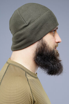 Profile of Bearded Man Wearing Olive Green Winter Hat