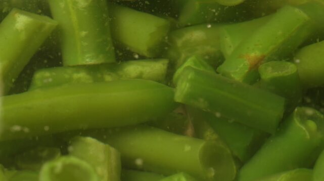 Boiling green string beans cooking in hot water