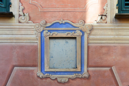 Detail of a typical vintage colourful ornate Ligurian painted gable with template in Genova, Italy