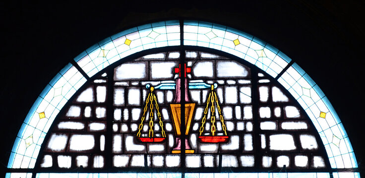 Hemisphere colourful burning glass with antique scale, symbol of justice, and black background