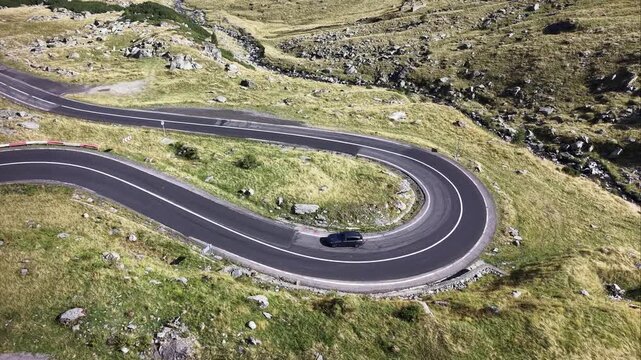 Aerial view of cars on hairpin curve of Transfagarasan Road in Sibiu, Romania