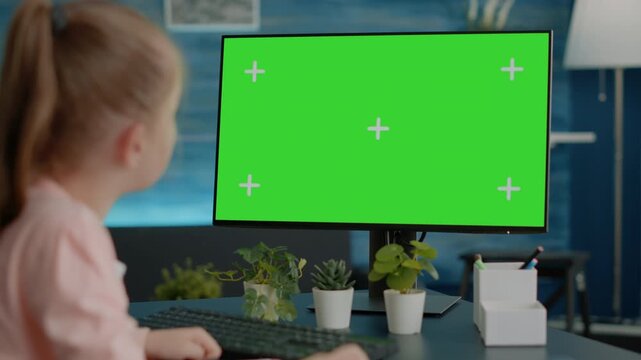 Green screen, mockup and computer with schoolgirl looking at a large blank display, for chroma key editing, screen replacement, digital advertising, education content and customizable media.