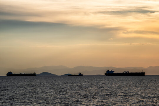 Crude oil tankers in the sea at sunset. Oil and gas industry. Tankers crude oil carrier ship designed for transporting grude oil