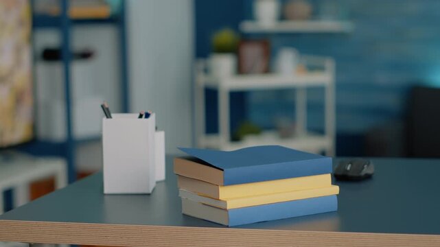 Study, books and workspace on an empty home desk with stacked books, pencil holders and computer mouse, arranged for homework, online learning, school preparation, organization and copy space.