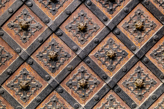 Antique wooden door with iron grilles