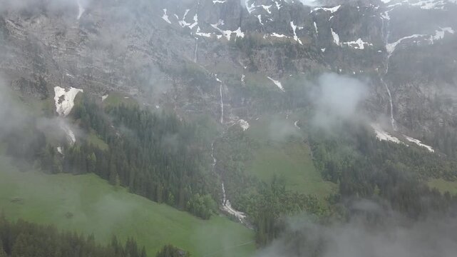 Snow patches and waterfalls, Bi de Sibe Br&uuml;nne, sources of the Simme, drone shot, Lenk, Bern, Switzerland