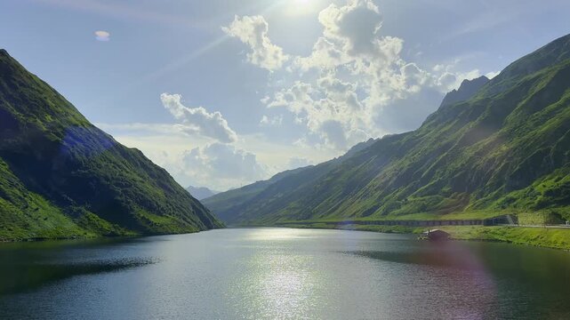 View From Glacier Express Train on a Beautiful Swiss Alps with Alpine Lake Oberalp See and Mountainscape in a Sunny Summer Day with Blue Sky and Clouds in Oberalp Pass, Sedrun, Surselva, Oberalp, Gri