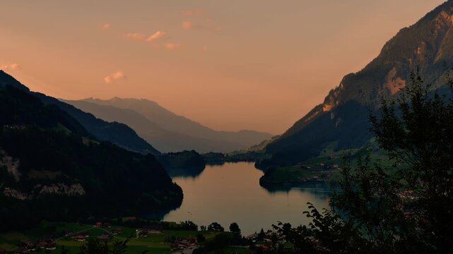 Panoramic View over Lake Lungern and Village with Mountainscape in Dusk in Summer in Lungern, Obwalden, Switzerland