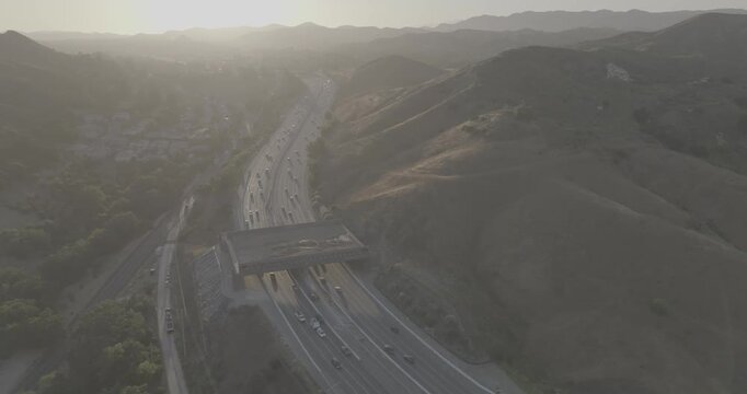 Backlit Aerial of a Highway and Wildlife Crossing in Hazy Hills