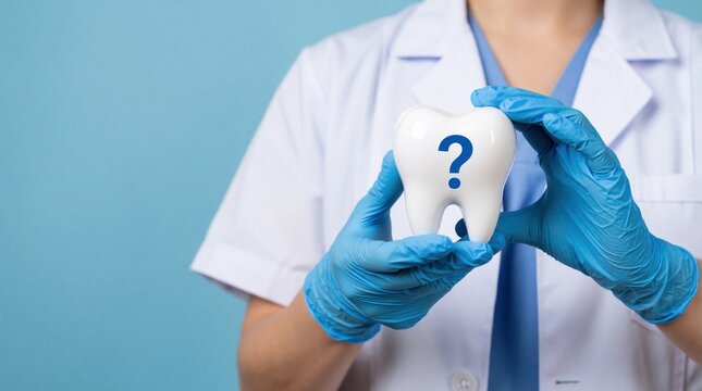 Female dentist in white uniform, blue gloves holds large white tooth model with blue question mark. Medical professional offers dental advice consultation. Healthcare expert explains oral hygiene