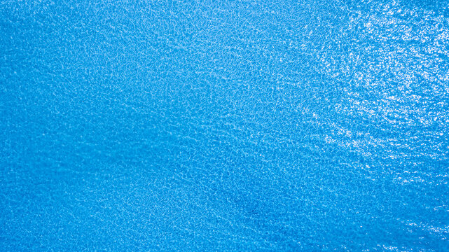 Top view of deep blue sea water surface with small ripples, aerial drone shot of turquoise ocean texture at island , abstract nature background	
