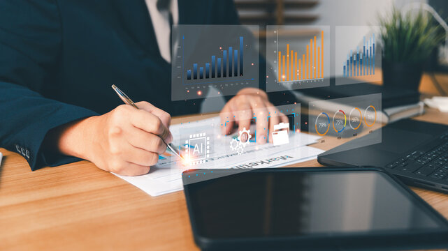 Businessperson writing financial data reports and analyzing marketing performance using AI technology, charts, and digital dashboards for corporate business growth and strategic planning