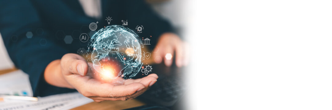 Businessman holding digital global network and futuristic earth hologram with technology icons, managing worldwide business connectivity, innovation, and international corporate data communication