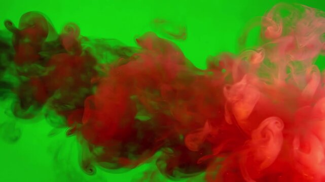 Whirling fire smoke trails expanding and diffusing slowly across a chromakey green screen surface for video editing