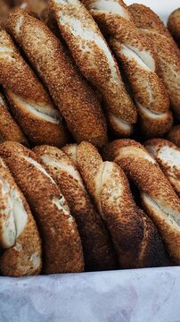 Rows of sesame bread loaves displayed at a bakery for sale