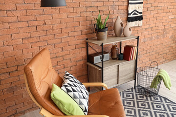 Interior design and home comfort, cozy living room with leather armchair and brick wall for modern lifestyle and domestic relaxation © Pixel-Shot