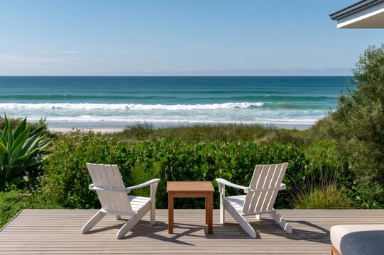 Beach house deck with adirondack chairs facing ocean waves