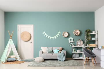 Childhood development and nursery interior, cozy playroom with teepee tent and soft furniture in a modern home for kids and family lifestyle design © Pixel-Shot