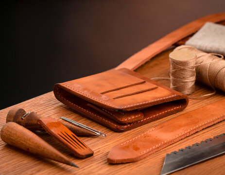 Handcrafted Brown Leather Wallet on Traditional Leatherworking Table