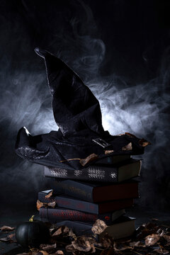 black witch hat on a stack of books