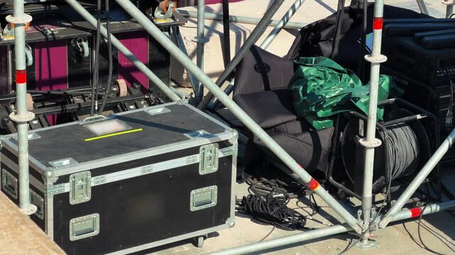 Flight case and cables on stage scaffolding, concert production equipment footage. High quality 4k footage