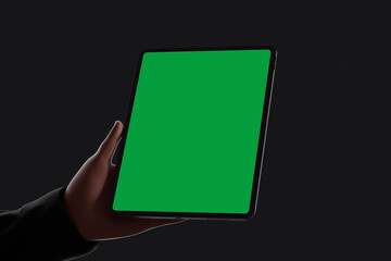Hands holding green screen tablet in dark background mockup © Rielismee