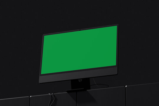 Green screen all in one desktop computer angled view in dark room mockup